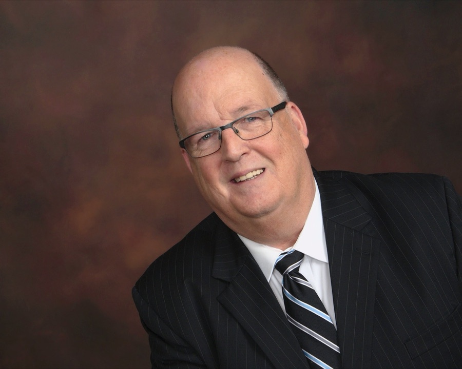 Bill Brown, President of New England Hospitality Resources, in a pinstripe suit
